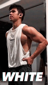 a man in a white tank top and black shorts